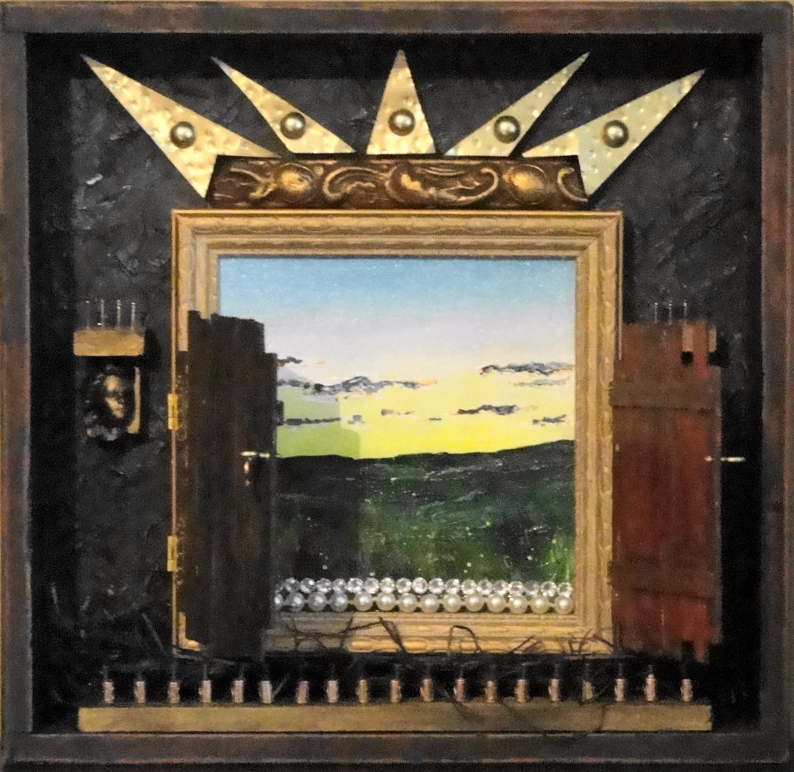 Inset into a frame is a small framed landscape painting of a field. A little wooden gate is attached in front of this painting with a latch with which the gate can be opened to see the field. Above the field picture is a hammered brass crown. A small plaster head of an angel sits at each side of the field painting.